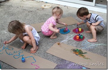 Painting sheets of cardboard outside