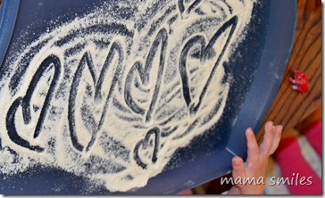 Emma draws hearts in corn meal flour
