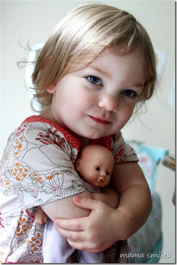 Lily hugs her baby doll