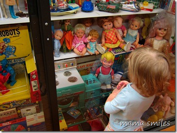 Lily admires baby dolls in the Vermont Toy Museum