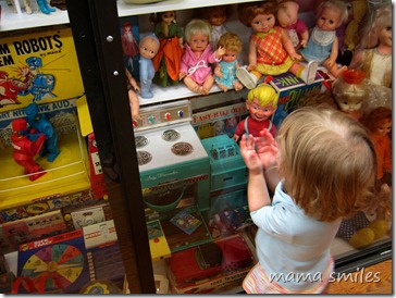 Lily admires baby dolls in the Vermont Toy Museum