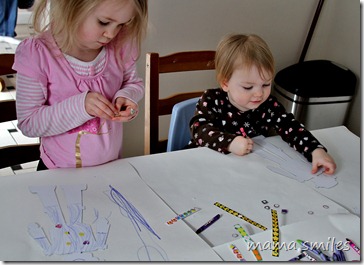 Emma and Lily decorate robots