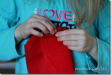 Emma sewing her doll a bag