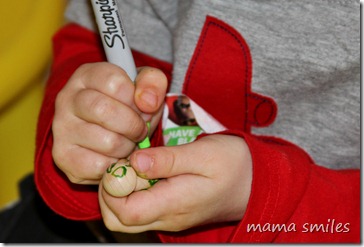 Johnny decorates his peg doll