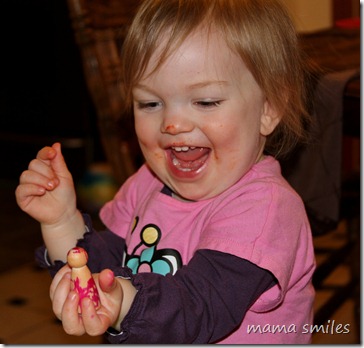 Lily admires her peg doll