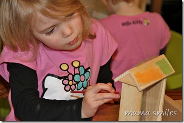 Emma paints a her bird feeder