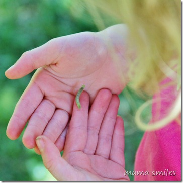 Emma holds a caterpillar