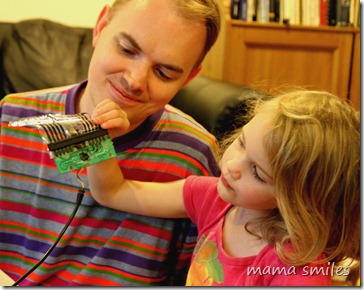 Emma examines the circuitboard to an old dance mat