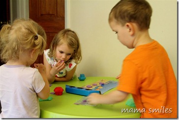 All three kids play with moon dough
