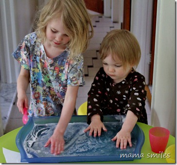 Emma and Lily play with baking soda and vinegar
