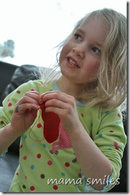 Emma sewing a felt heart