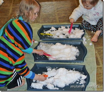 Emma, Johnny, and Lily play with snow brought in from outdoors