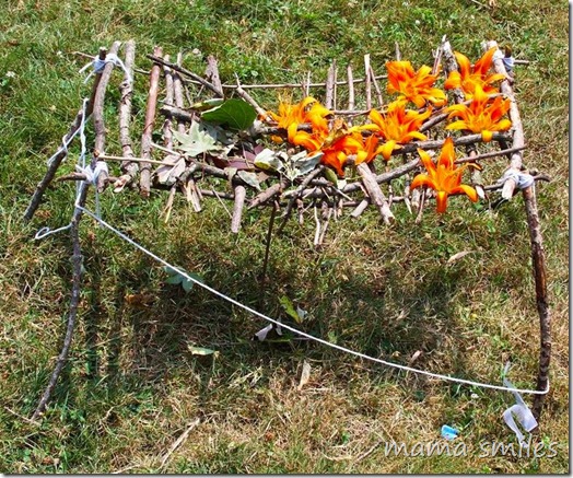 tree house from sticks, leaves, flowers, and yarn