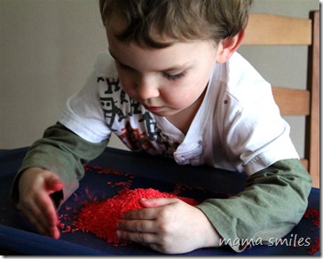 Johnny plays with colored grains of rice